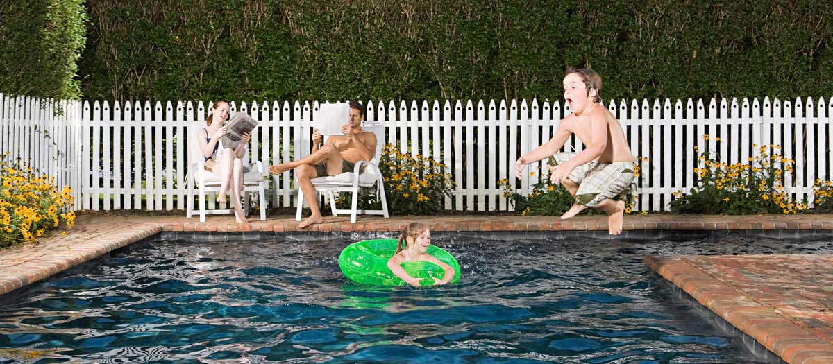 A family playing by the poolside