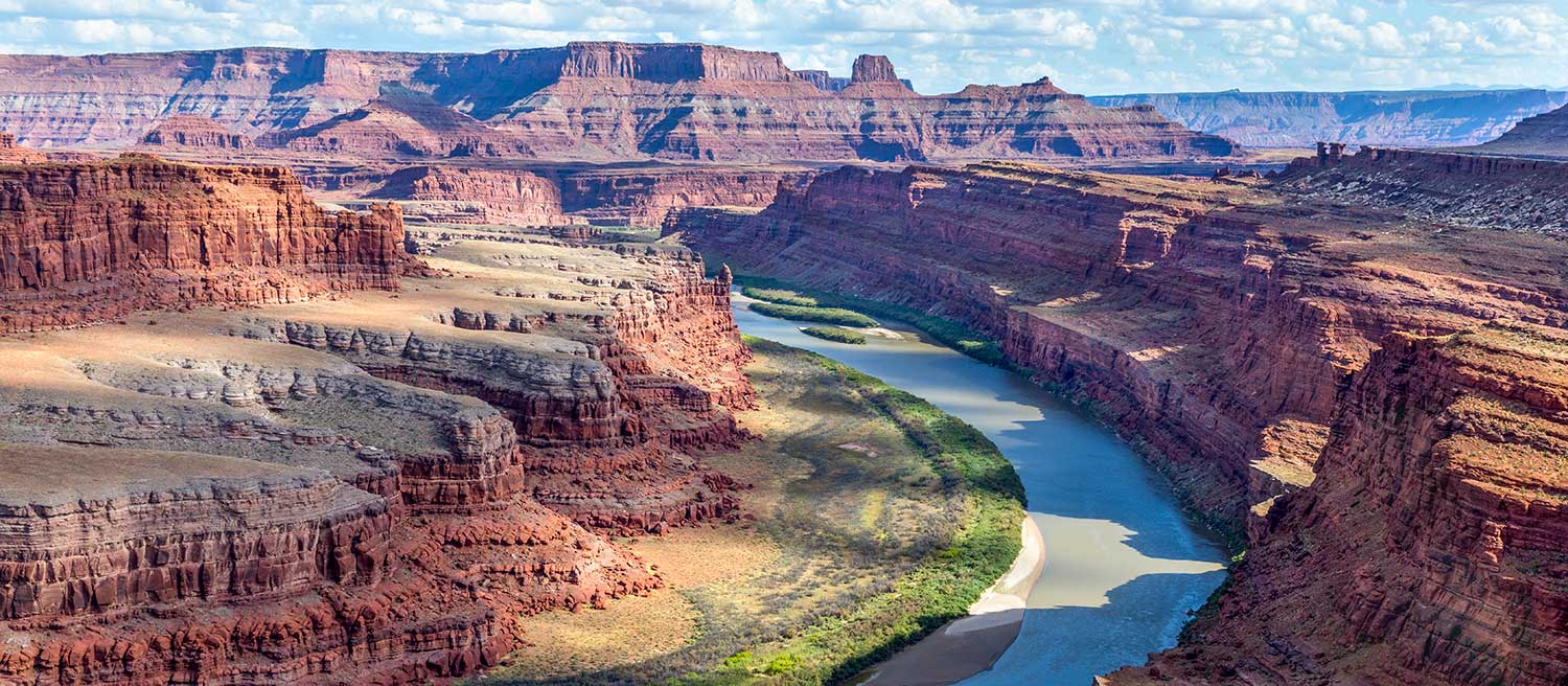An aerial shot of the Colorado River winding through red cliffs
