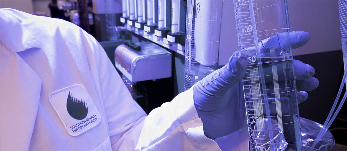 Lab worker holding beaker
