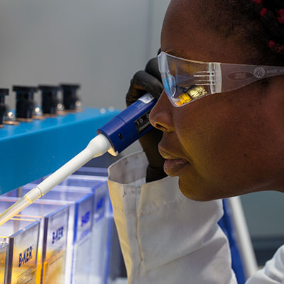 Lab worker holding beaker