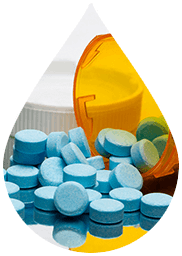 blue pills spilling out of a prescription bottle