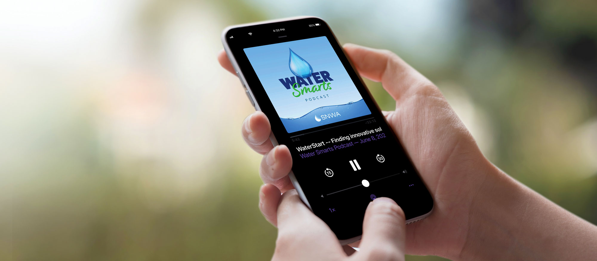 Closeup of hand holding a mobile device showing the Water Smarts Podcast app