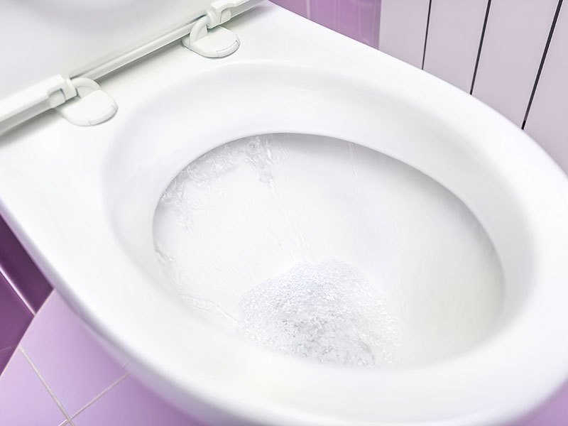 close up of a toilet bowl as it flushes