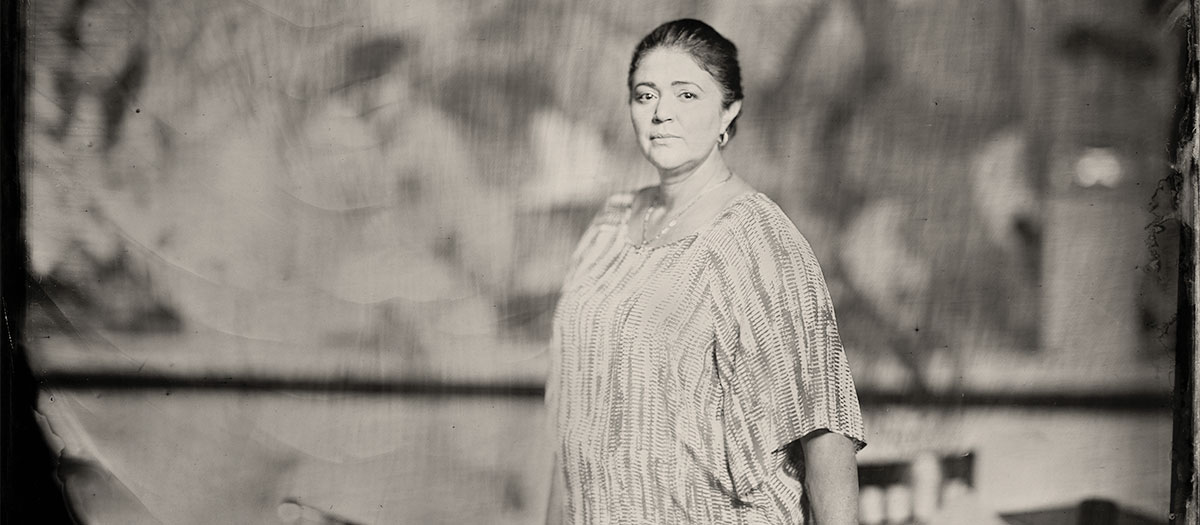 Owner of Dona Marias Tamales restaurant standing in one of her kitchens