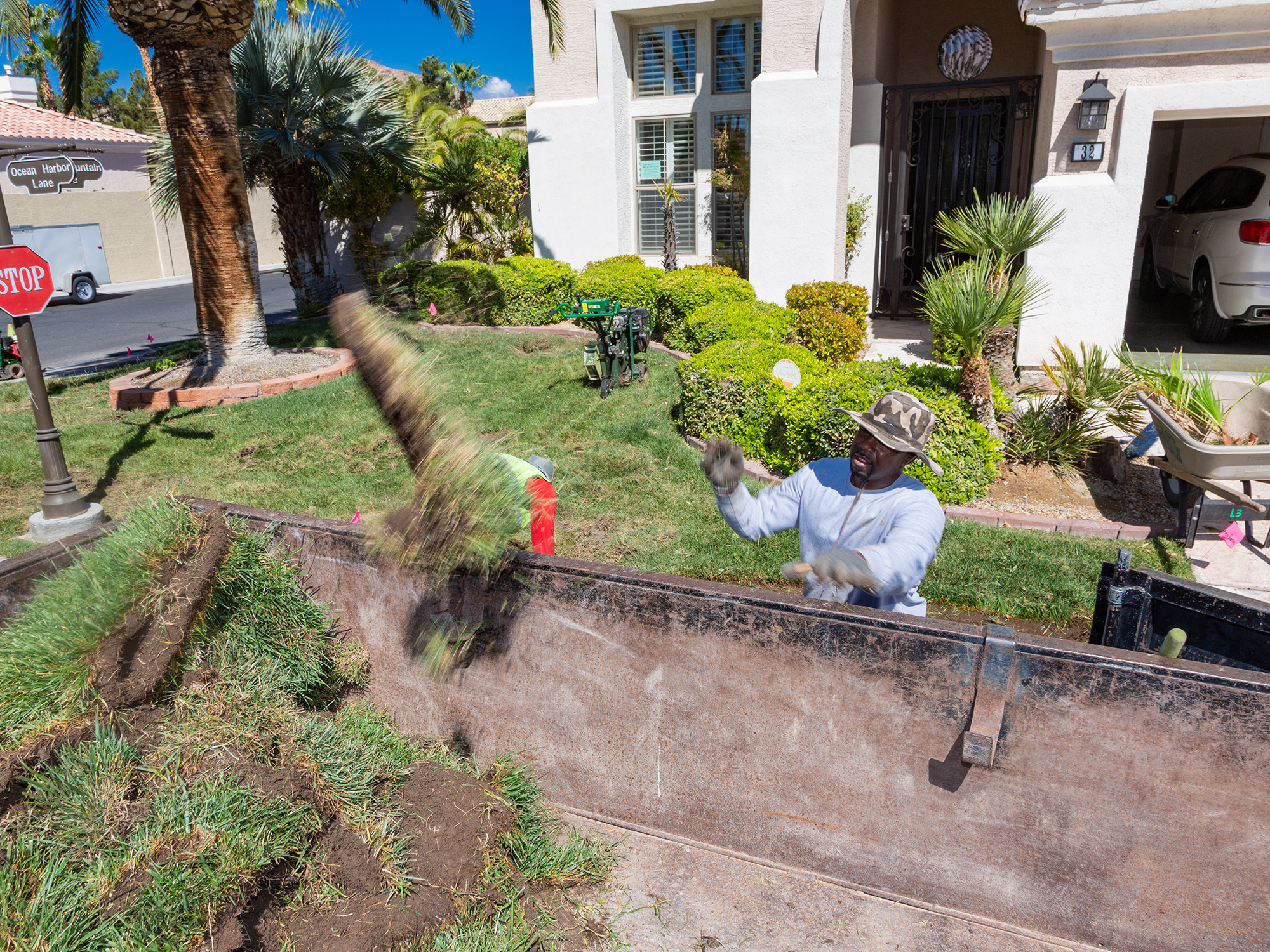 Man throwing turf in garbage can 